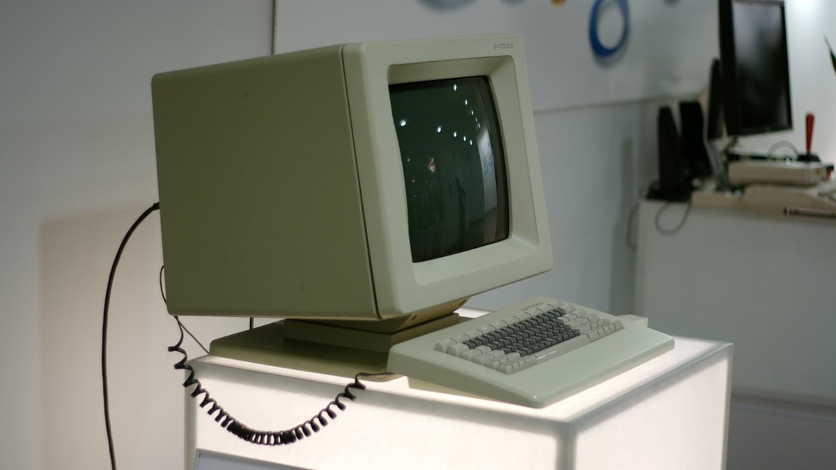 En beige Symbolics LISP-dator med bildskärm och tangentbord står på ett museum.